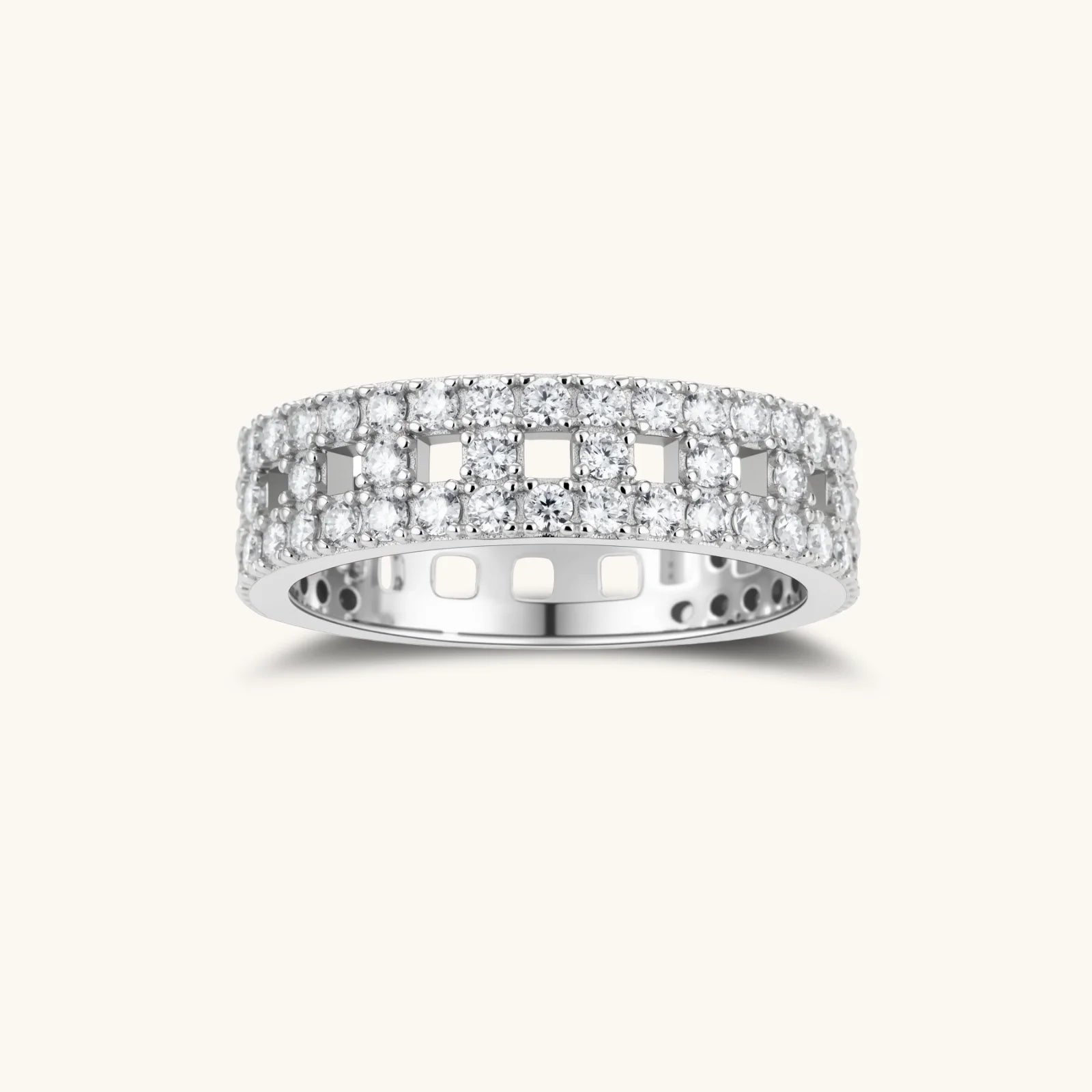 Wide sterling silver ring with three rows of brilliant moissanite stones in geometric pavé setting on white background
