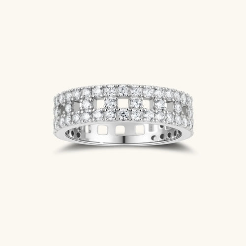 Wide sterling silver ring with three rows of brilliant moissanite stones in geometric pavé setting on white background