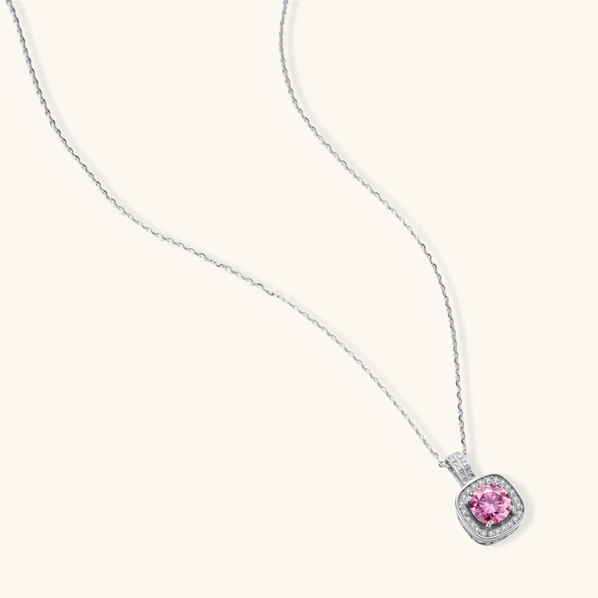 Sterling silver necklace with cushion-cut pink moissanite in diamond halo setting on white background