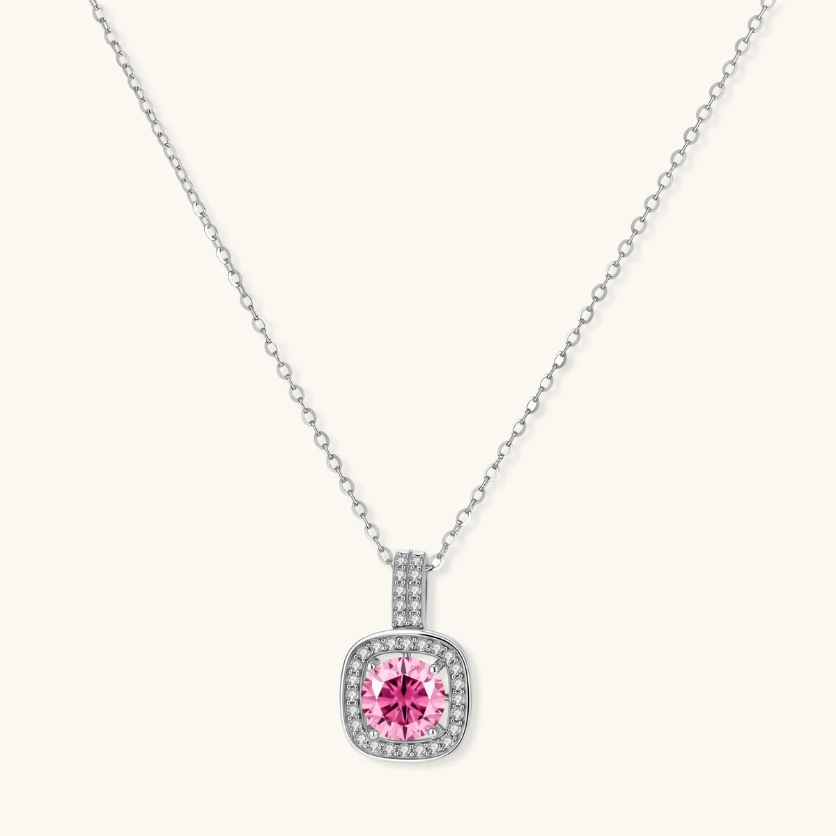 Sterling silver necklace with cushion-cut pink moissanite in diamond halo setting on white background