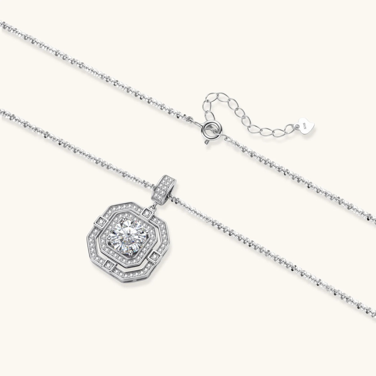 Sterling silver octagonal pendant necklace with brilliant moissanite center stone and halo setting on white background.