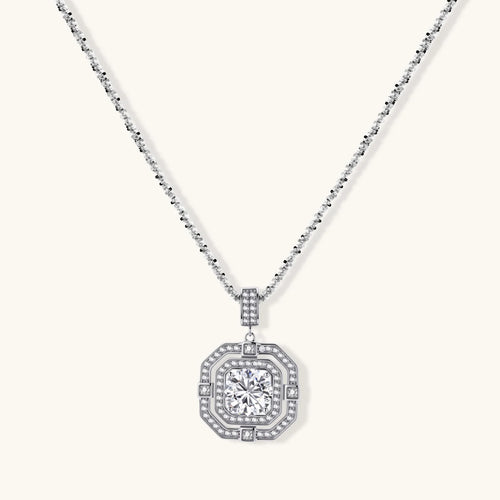 Sterling silver octagonal pendant necklace with brilliant moissanite center stone and halo setting on white background.