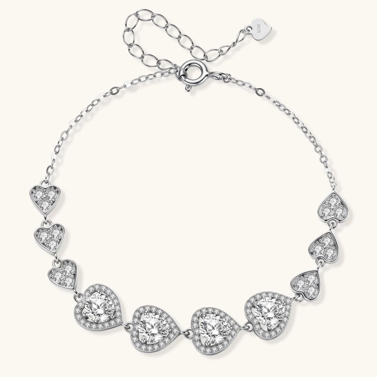 Sterling silver bracelet with graduated heart-shaped links and sparkling moissanite stones in VVS1 clarity on white background.