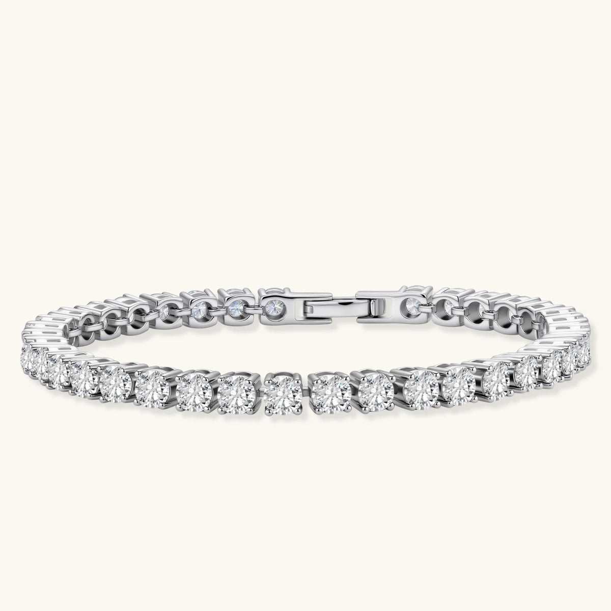 Sterling silver tennis bracelet with continuous row of brilliant moissanite stones and secure clasp closure on cream background.