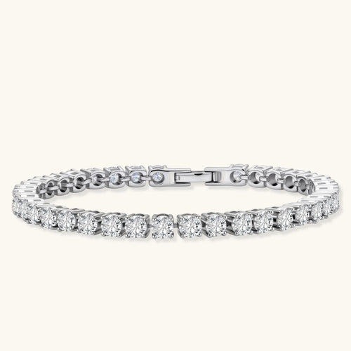 Sterling silver tennis bracelet with continuous row of brilliant moissanite stones and secure clasp closure on cream background.