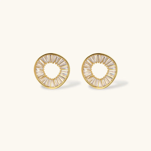 Gold-plated necklace and earring set with circular CZ crystal pendants featuring radial design on cream background