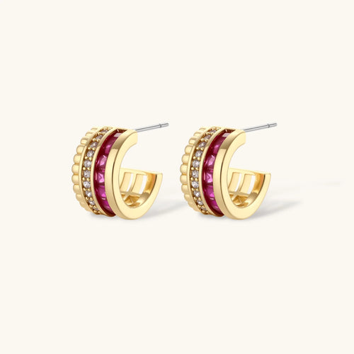 Three-piece jewelry set featuring 14K gold plated pieces with deep red cubic zirconia stones and clear crystals on cream background.