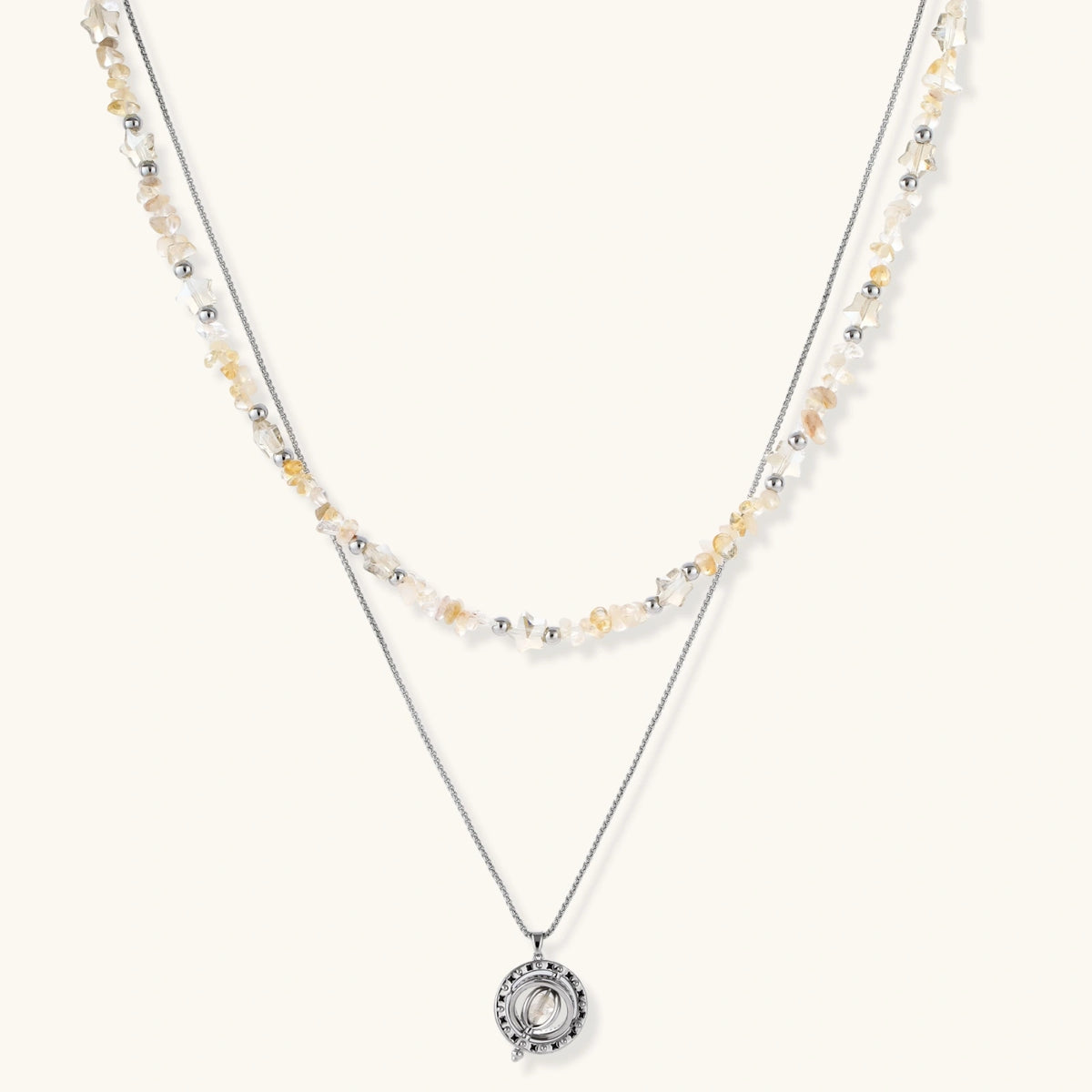 Complete jewelry set featuring citrine stone chips, silver beads, and cosmic circle pendants on cream background.