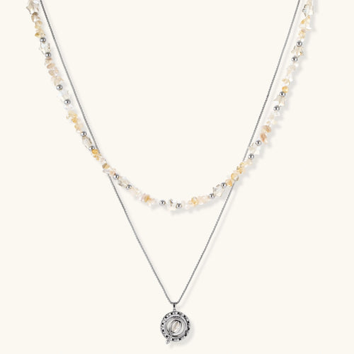 Complete jewelry set featuring citrine stone chips, silver beads, and cosmic circle pendants on cream background.