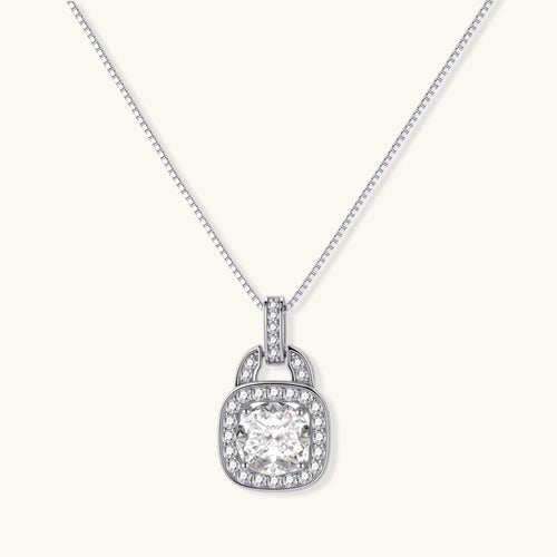 Sterling silver cushion halo pendant necklace featuring 2ct moissanite center stone with delicate box chain on neutral background.