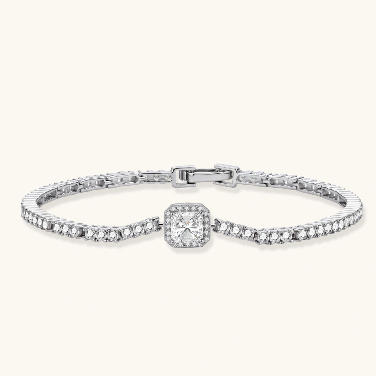 Sterling silver tennis bracelet with cushion-cut moissanite centerpiece surrounded by smaller stones in continuous setting