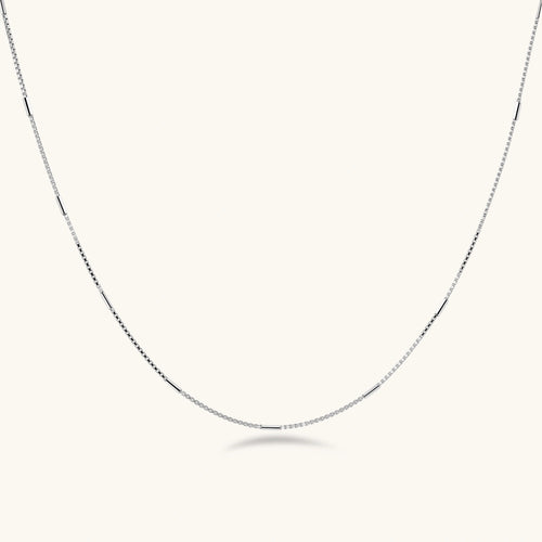 Delicate platinum-plated sterling silver necklace with alternating textured cubic links and smooth chain sections.