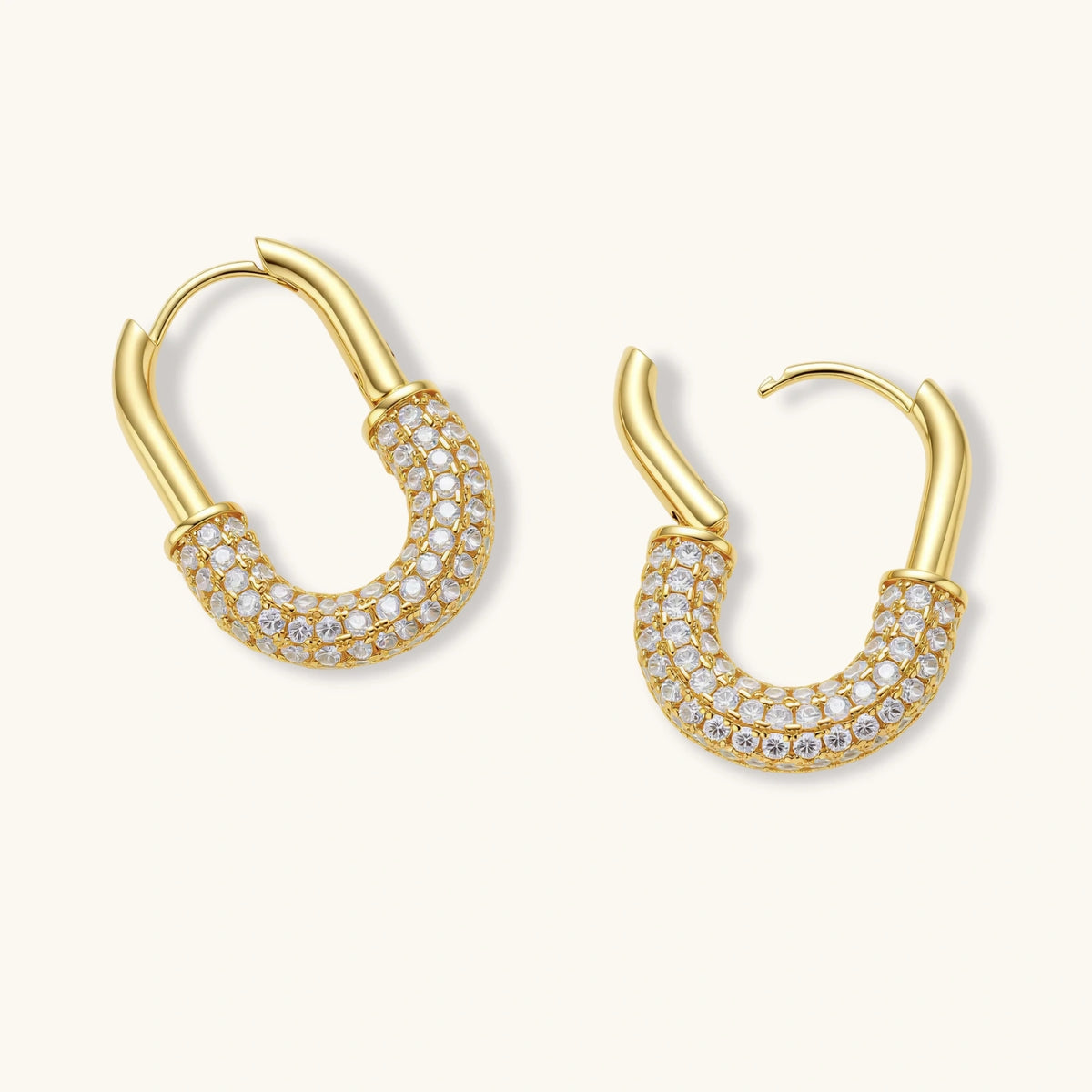 Gold-plated huggie hoop earrings with pavé zirconia stones covering the bottom curve, shown in open and closed positions.