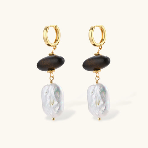 Gold hoop earrings with dark wood beads and baroque freshwater pearls, shown from multiple angles on cream background.