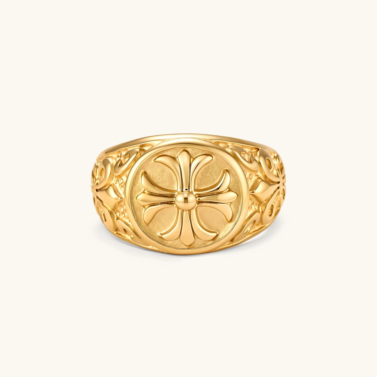 18K gold-plated stainless steel signet ring with ornate cross face and carved filigree scroll band, shown from three angles.