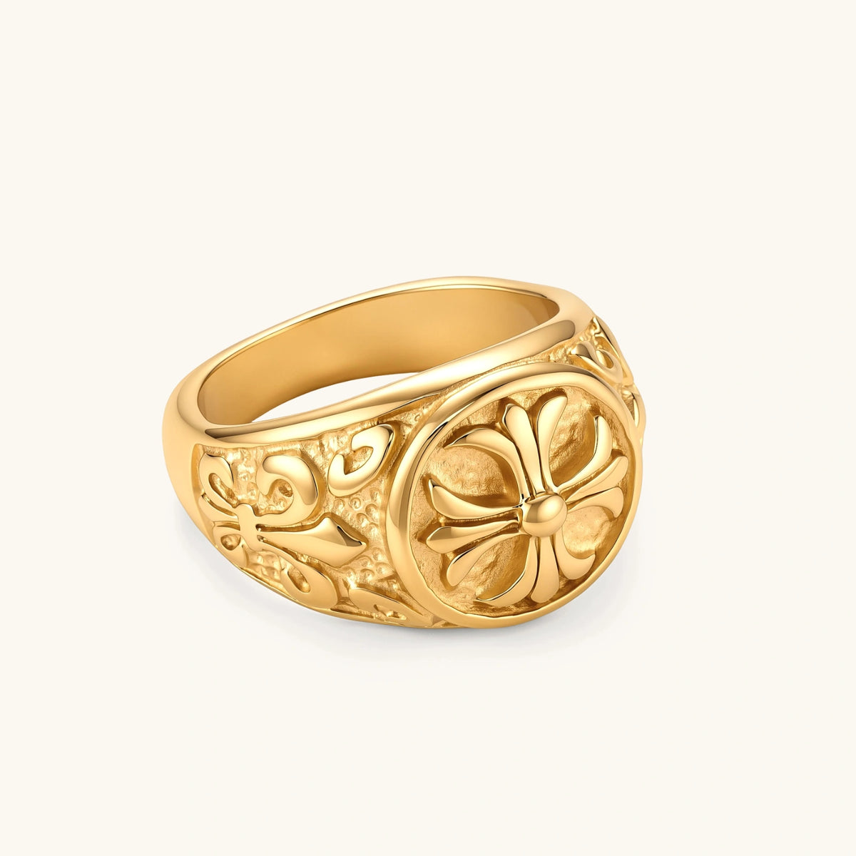 18K gold-plated stainless steel signet ring with ornate cross face and carved filigree scroll band, shown from three angles.