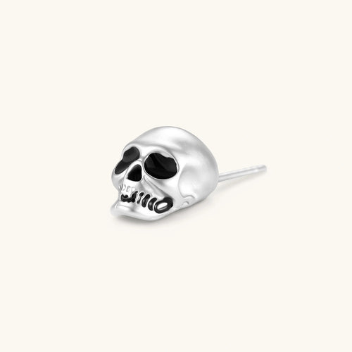Matte silver skull stud earring with black enamel eye sockets and detailed teeth, post backing, 316L stainless steel.