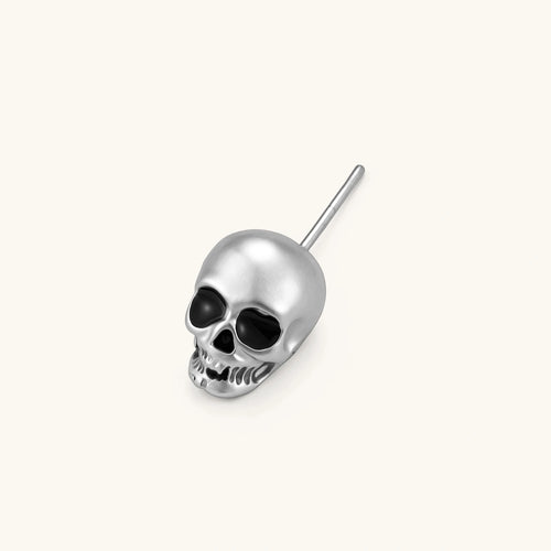 Matte silver skull stud earring with black enamel eye sockets and detailed teeth, post backing, 316L stainless steel.