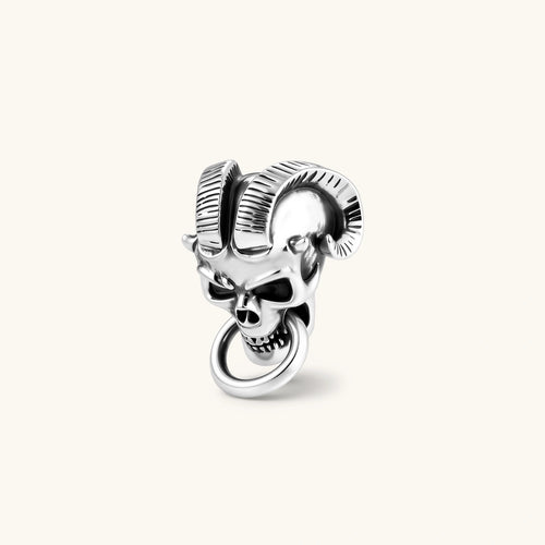 Silver 316L stainless steel stud earring shaped as a horned demon skull with ram horns and a dangling mouth ring.