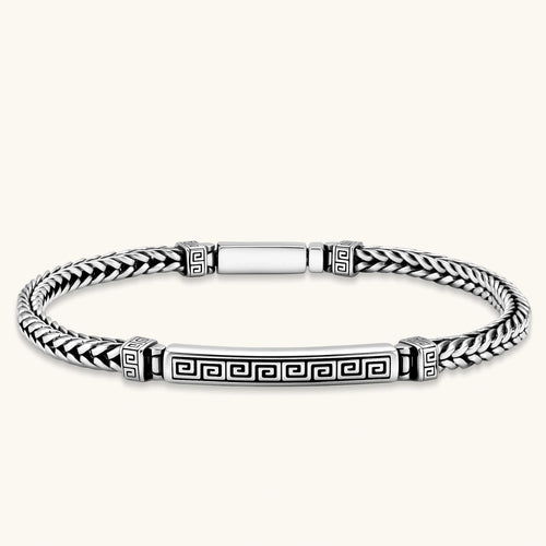 Silver stainless steel men's bracelet with braided foxtail chain, Greek key engraved bar, and decorative cube connectors.