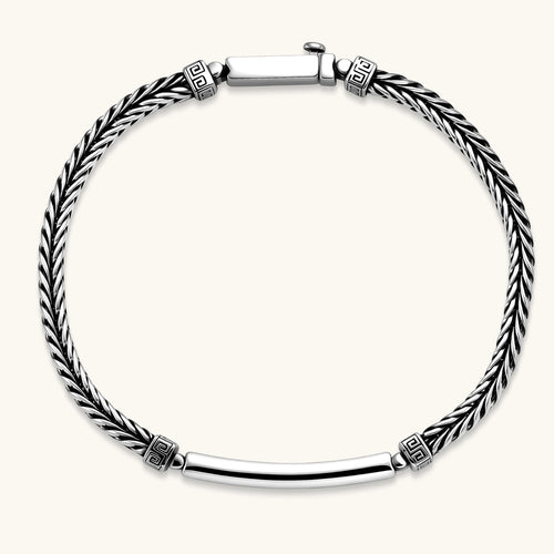 Silver stainless steel men's bracelet with braided foxtail chain, Greek key engraved bar, and decorative cube connectors.