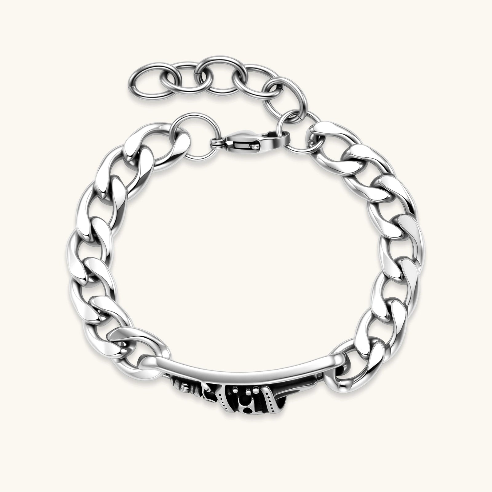 Silver 316L stainless steel Cuban chain bracelet with blackened skull and crown ID bar centerpiece, lobster clasp closure.