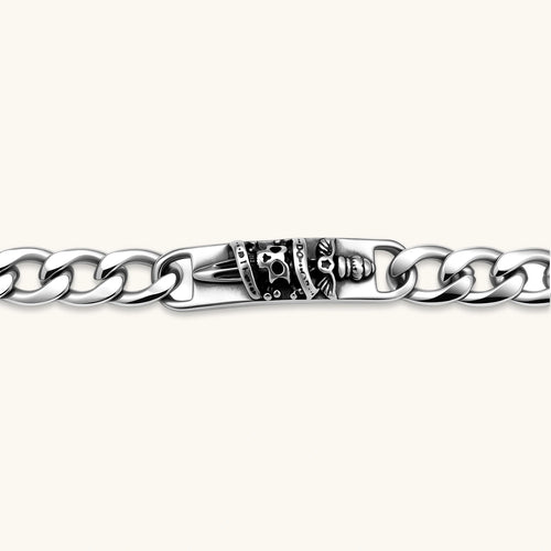 Silver 316L stainless steel Cuban chain bracelet with blackened skull and crown ID bar centerpiece, lobster clasp closure.