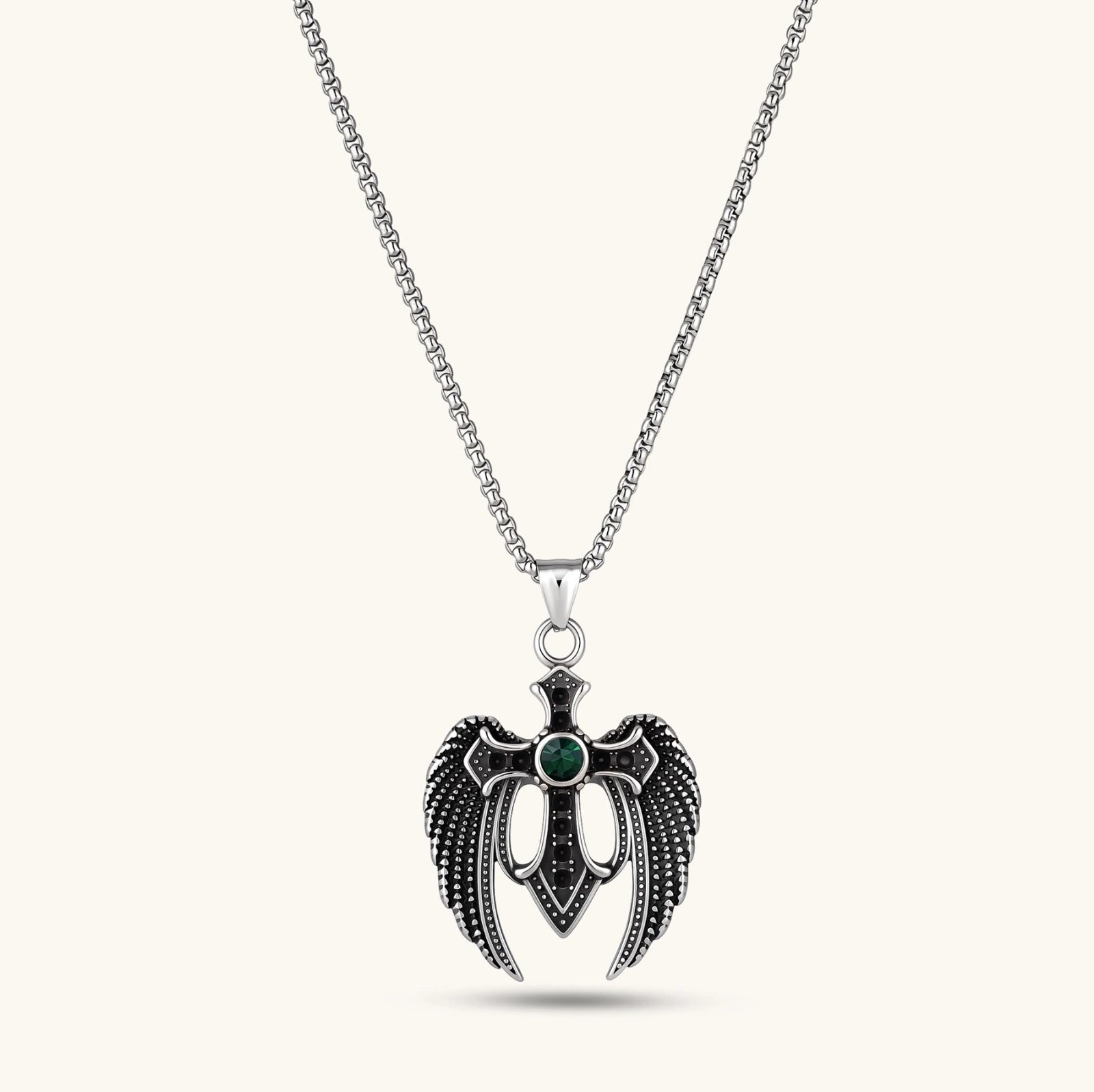 Silver stainless steel angel wing cross pendant necklace with green CZ center stone and black crystals on a box chain.