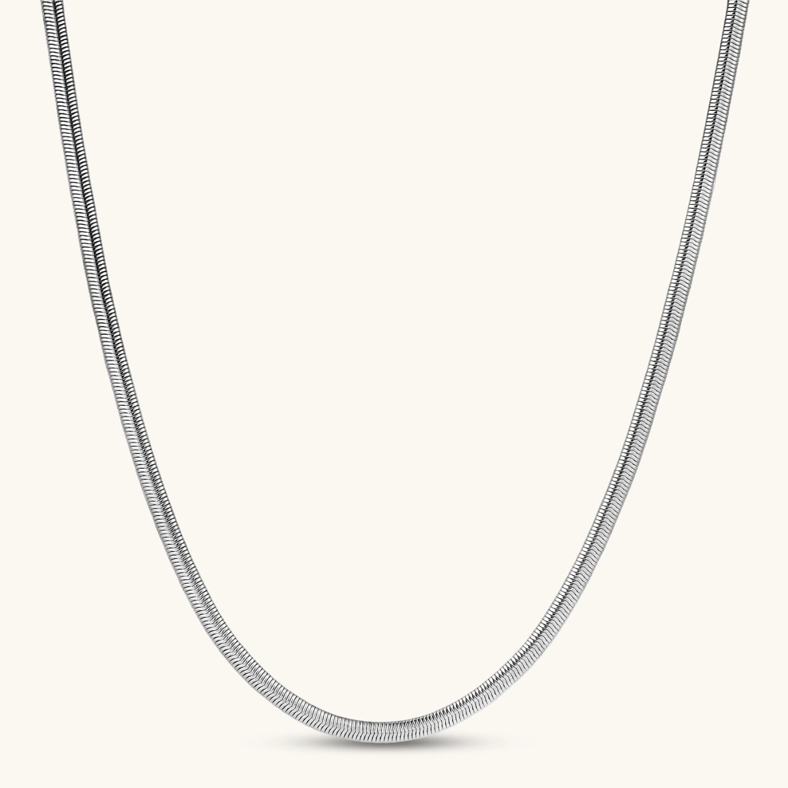 Two-tone twisted necklace with interlocked gold and silver ribbed snake chains, 6mm wide, on a white background.