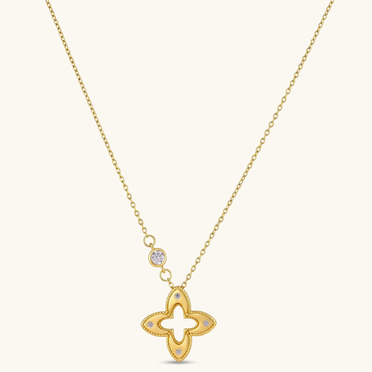 18K gold-plated 925 silver necklace with open four-petal flower pendant, CZ accents, bezel-set stone on chain, white background.