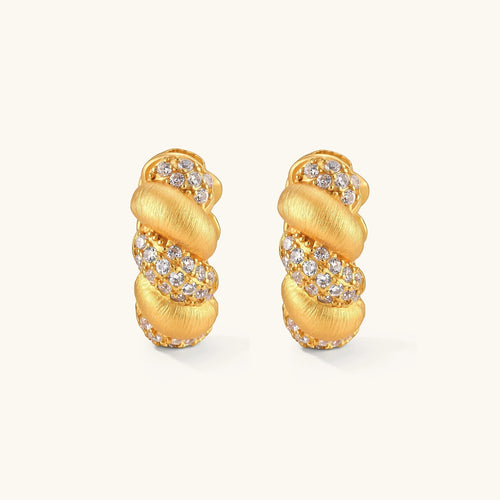 Pair of 18K gold-plated 925 silver huggie hoops with twisted braid texture and pavé cubic zirconia detailing, 15mm.