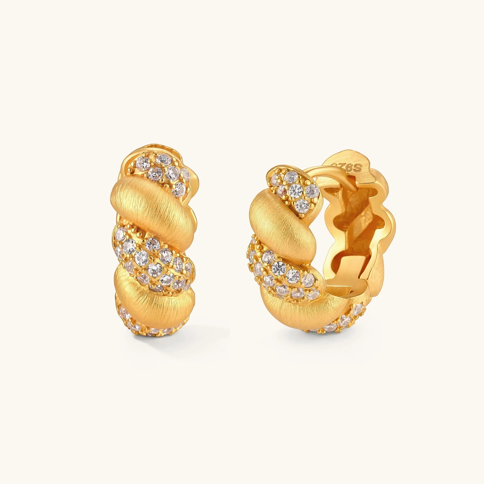 Pair of 18K gold-plated 925 silver huggie hoops with twisted braid texture and pavé cubic zirconia detailing, 15mm.