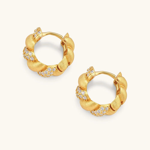 Pair of 18K gold-plated 925 silver huggie hoops with twisted braid texture and pavé cubic zirconia detailing, 15mm.