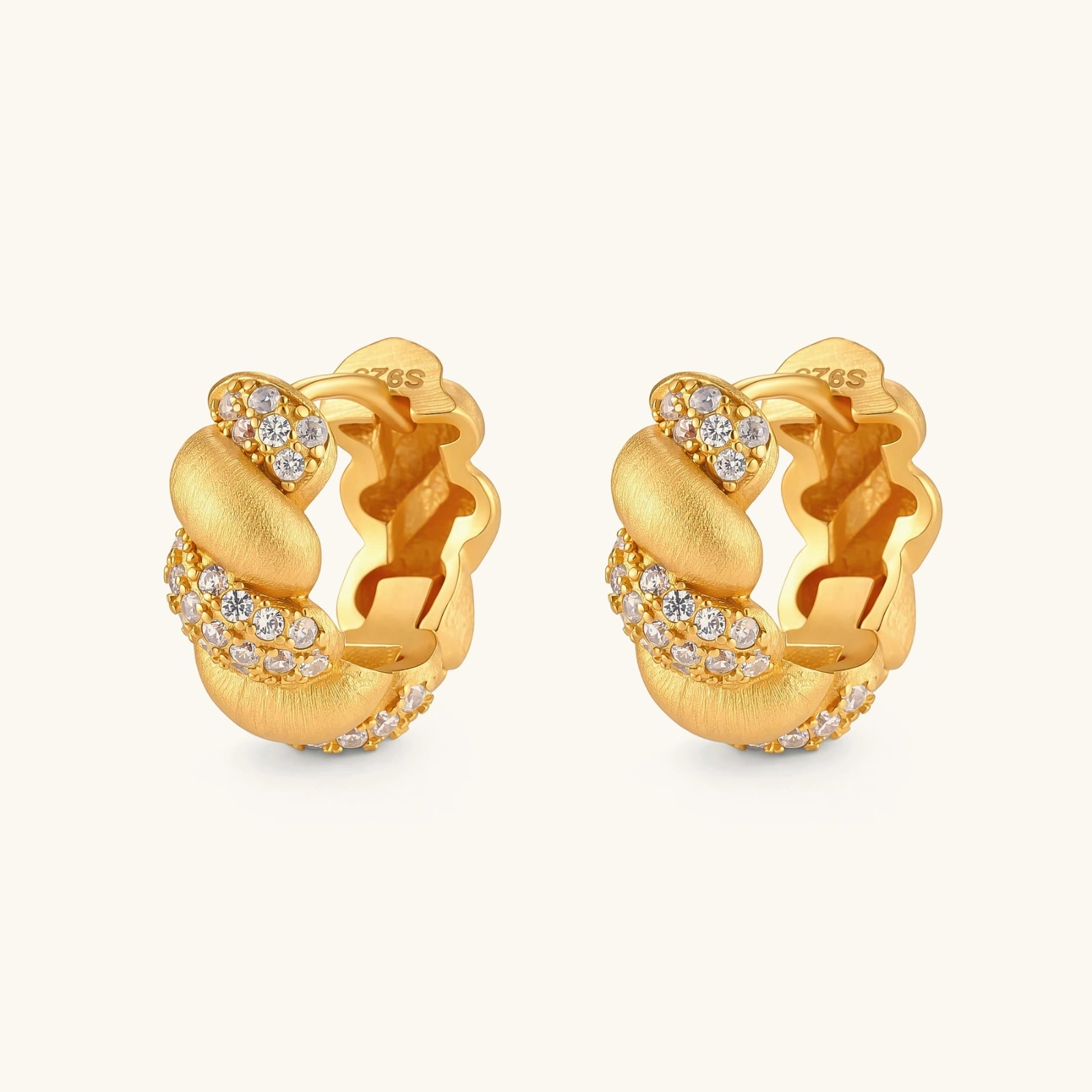 Pair of 18K gold-plated 925 silver huggie hoops with twisted braid texture and pavé cubic zirconia detailing, 15mm.